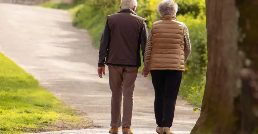 Older adult man and woman walking together to enjoy the health benefits of walking every day