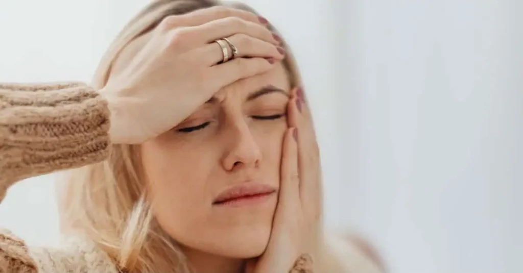 How to get rid of a headache as a woman holds her head in discomfort