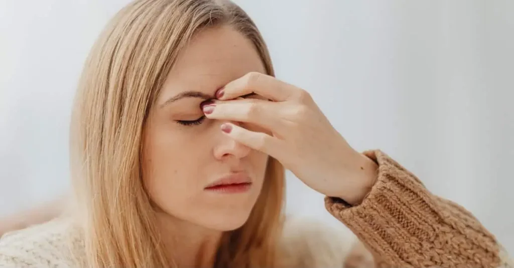 How to get rid of a headache as a woman stands with her hand on her head