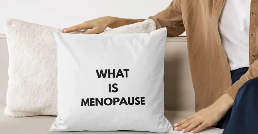 What is menopause? Woman holding a throw pillow with a menopause tag