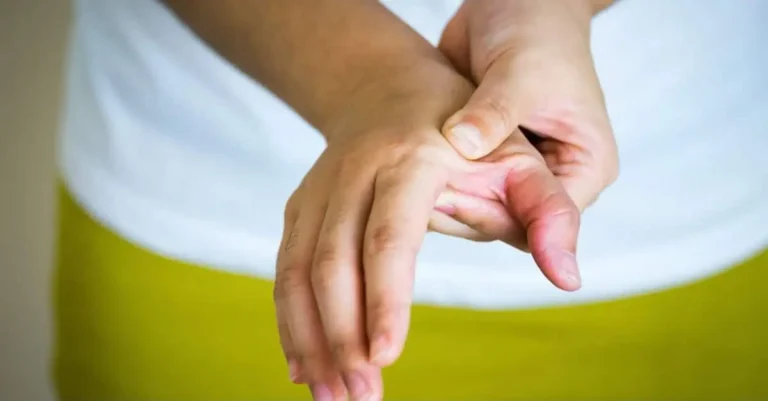 Man massaging his hands due to poor blood circulation