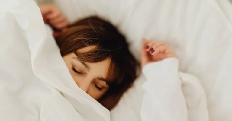 How Much Deep Sleep Do You Need? Woman sleeping in bed