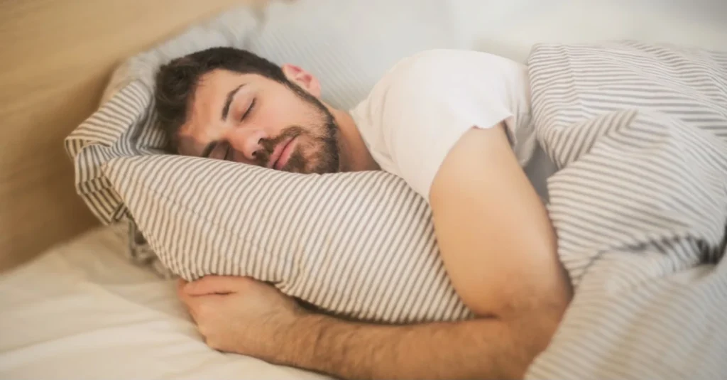 Man sleeping comfortably in his cozy bed