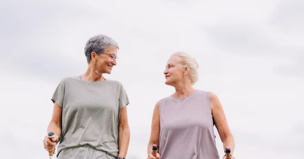 Two older women chatting while walking outdoors
