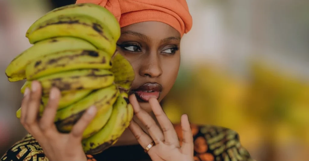 A woman holding a bunch of bananas to support healthy eating habits